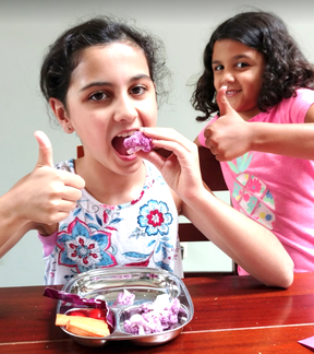 Kids eating purple cauliflower